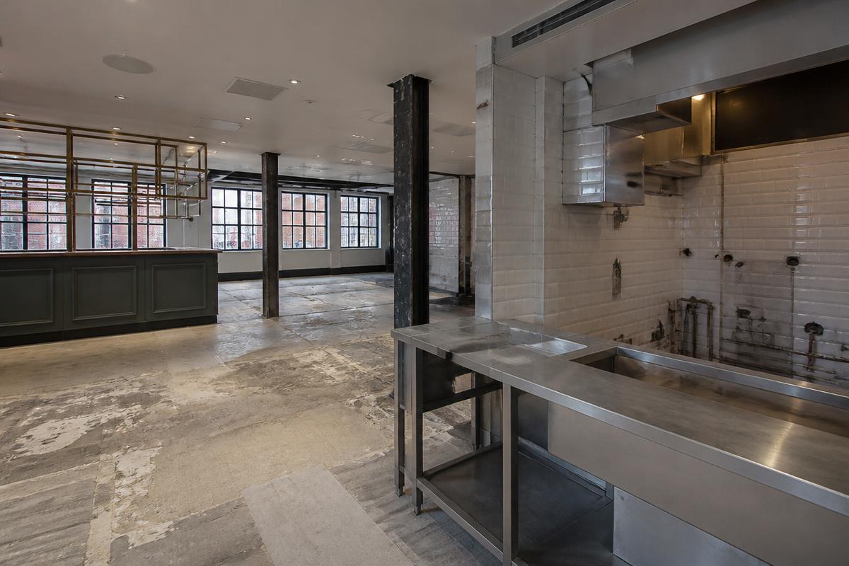 Restaurant interior with bar and kitchen fit-out partly removed